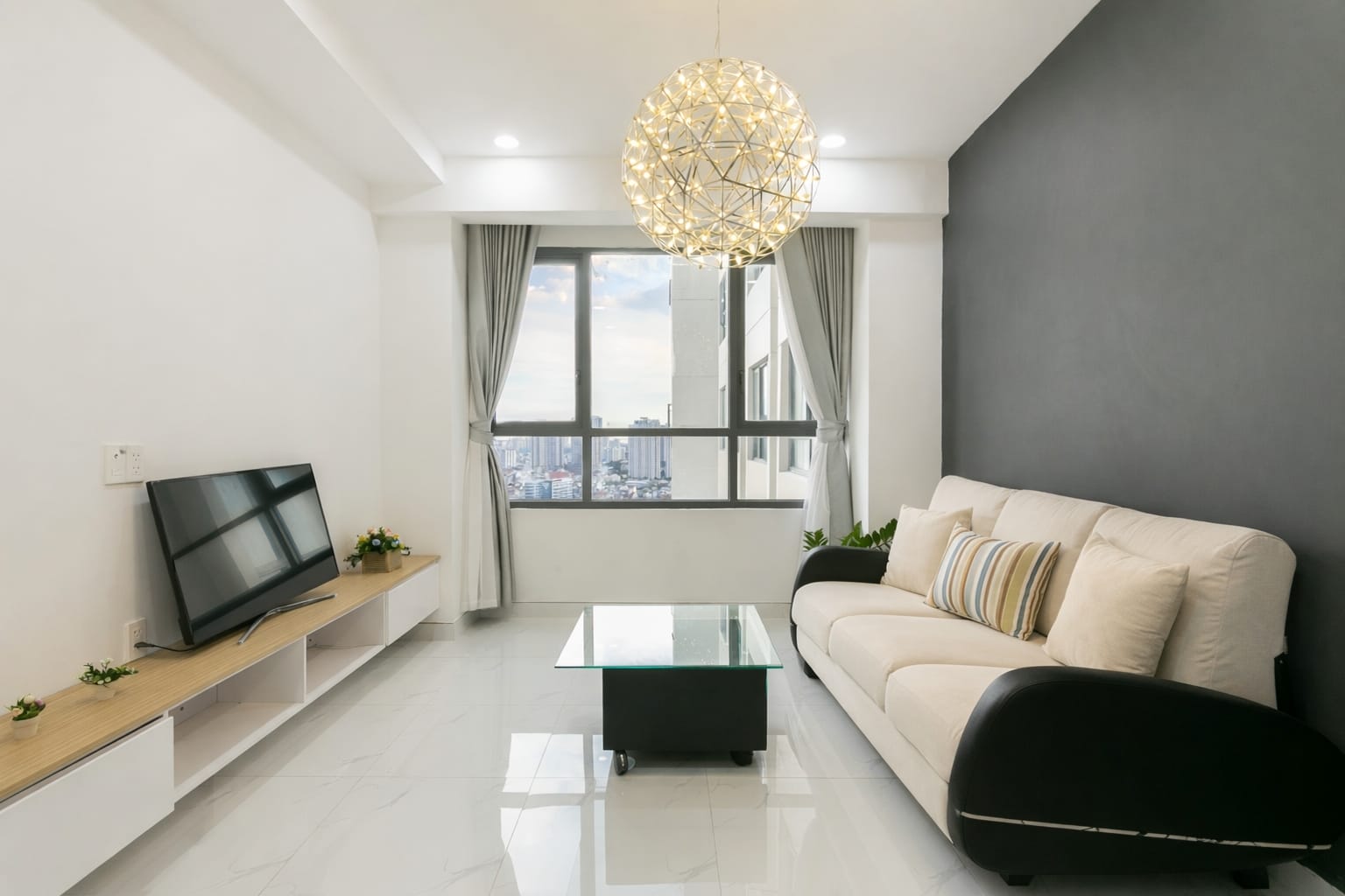 Open living room and kitchen space in a 2-bedroom apartment at Saigon Apartment