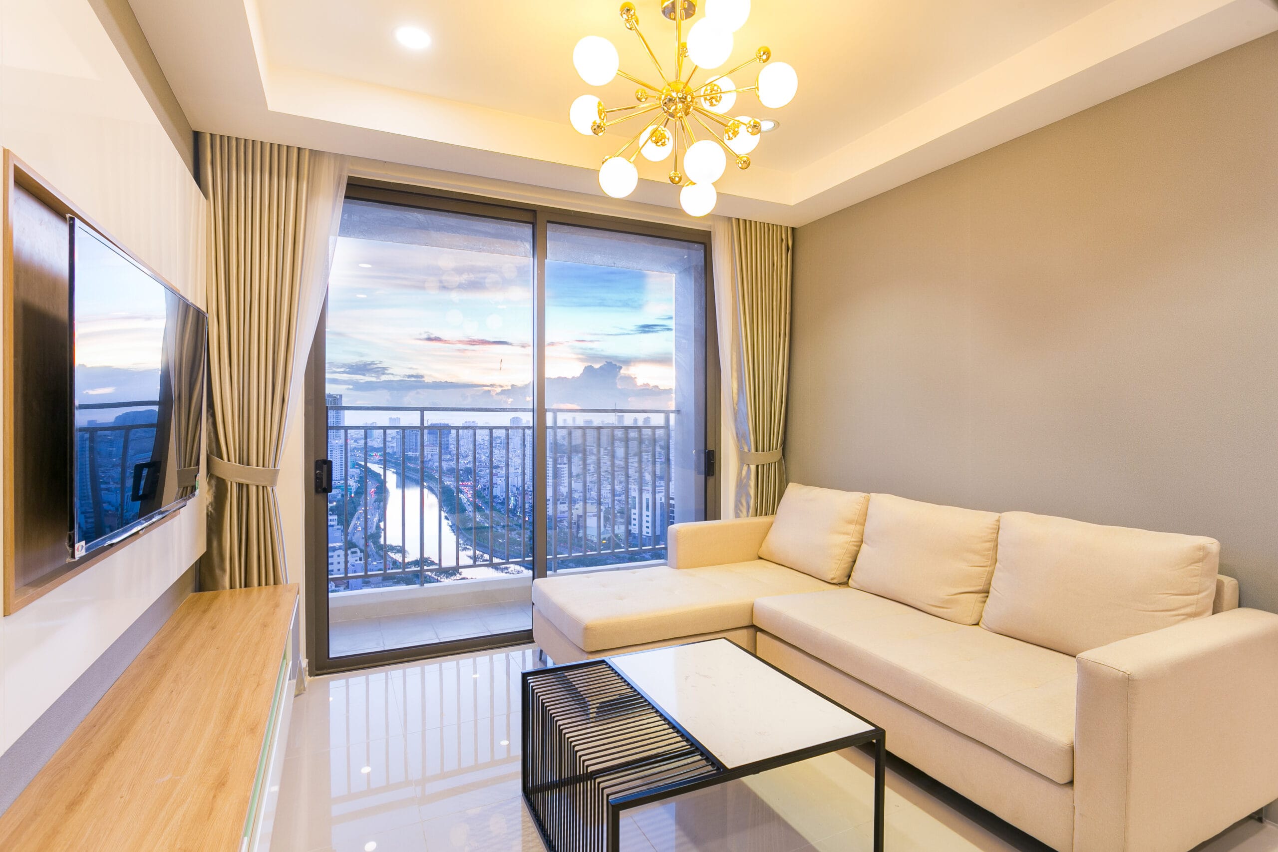 Sofa area and private balcony in 3 bedroom apartment in Ho Chi Minh City
